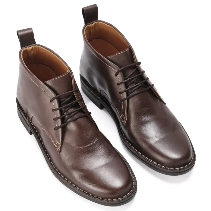 Pair of brown leather boots on a white background