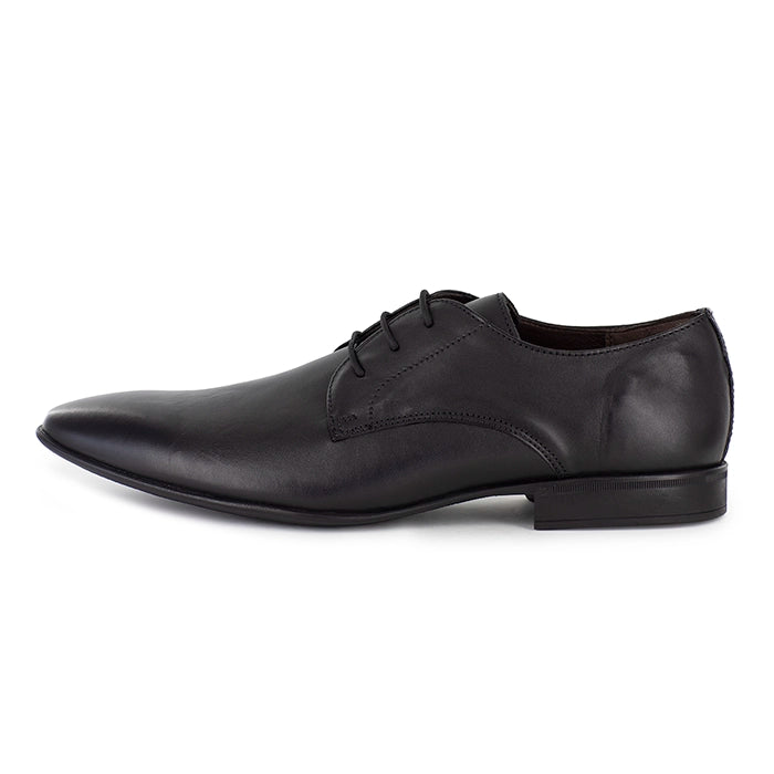 Black leather dress shoe on a white background