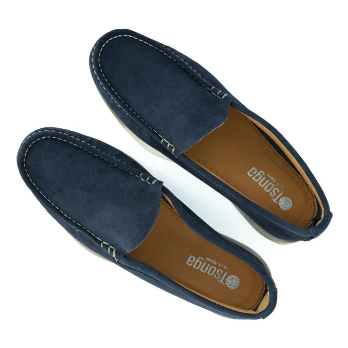 Pair of navy blue loafers with brown insole on a white background