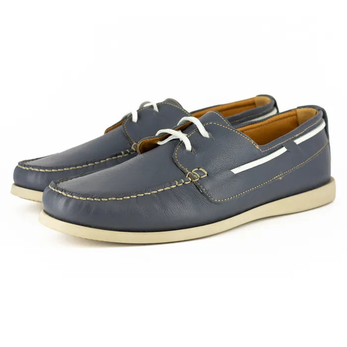 Pair of blue leather shoes with white laces on a white background