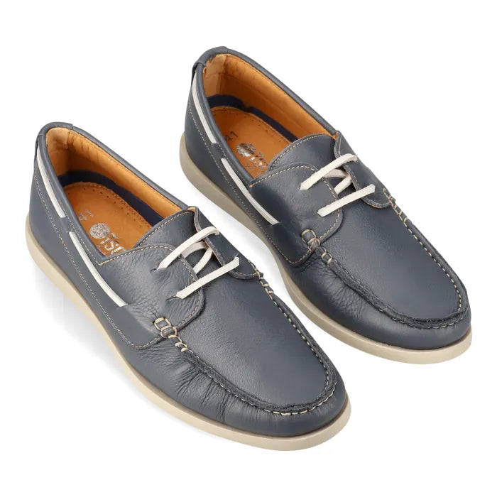 Pair of blue leather boat shoes on a white background