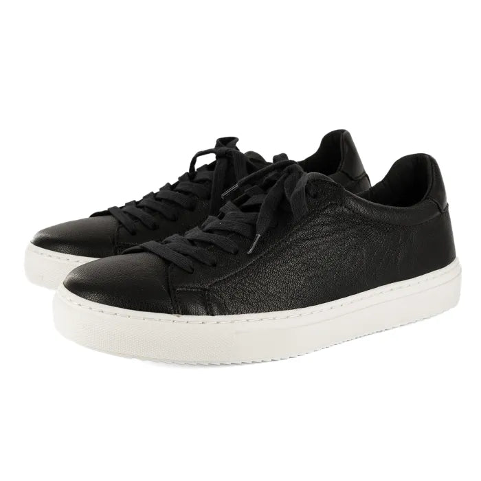 Black sneakers with white soles on a white background