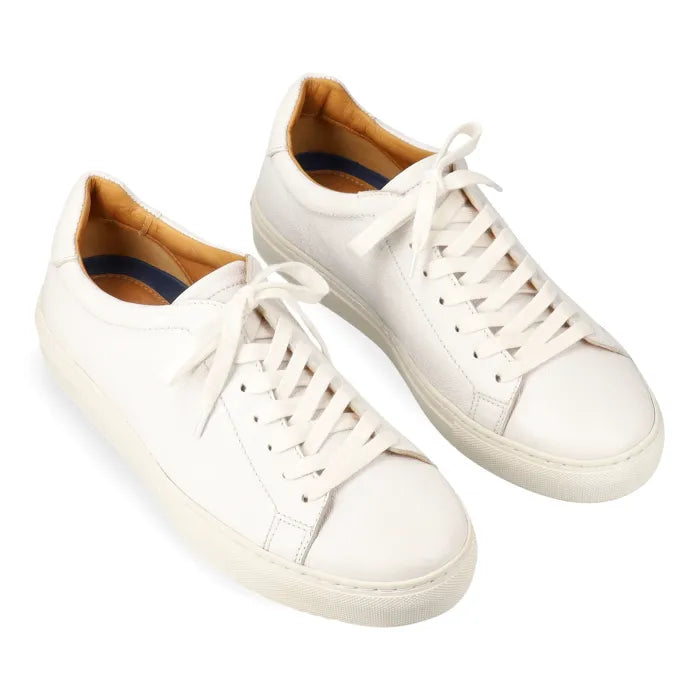 Pair of white sneakers with white soles on a white background