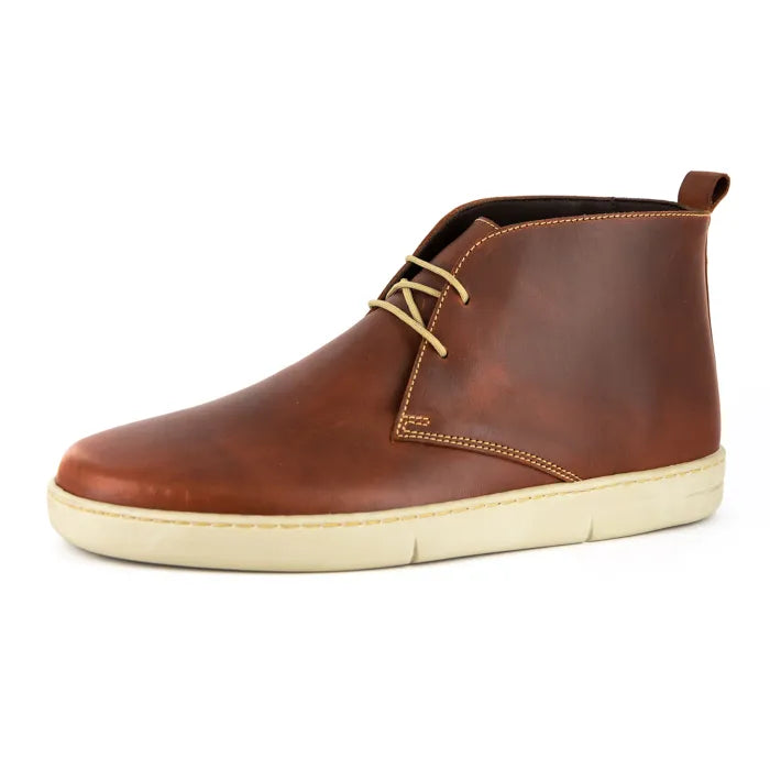 Brown leather chukka boot with beige laces on a white background