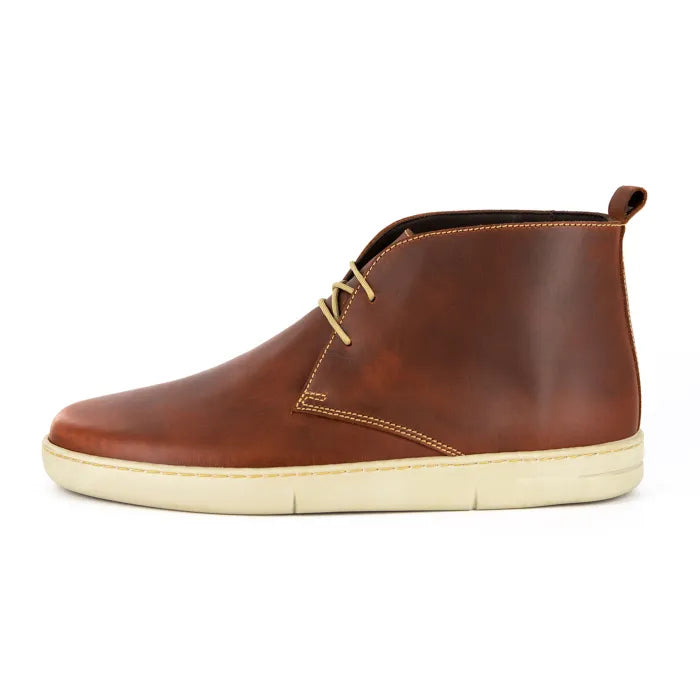 Brown leather shoe with a white sole on a white background