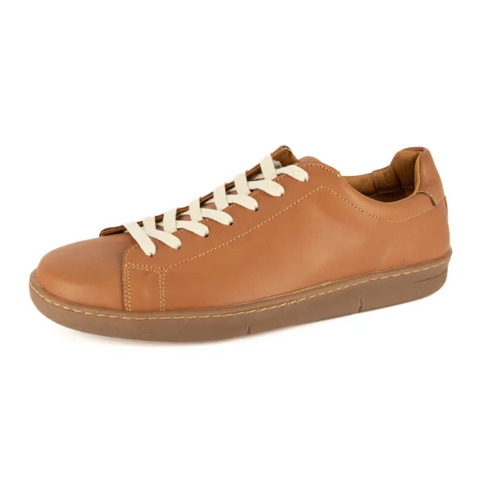 Tan leather sneaker with white laces on a white background