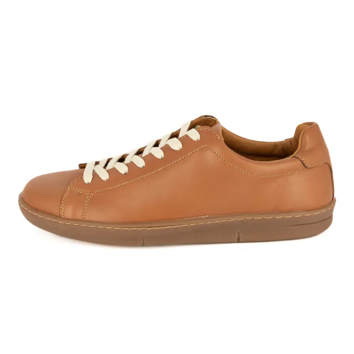 Tan leather sneaker with white laces on a white background