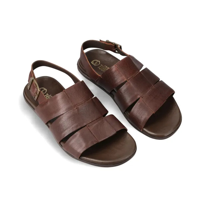A pair of dark brown leather slide sandals with wide woven straps and adjustable ankle straps, shown on a clean white background.