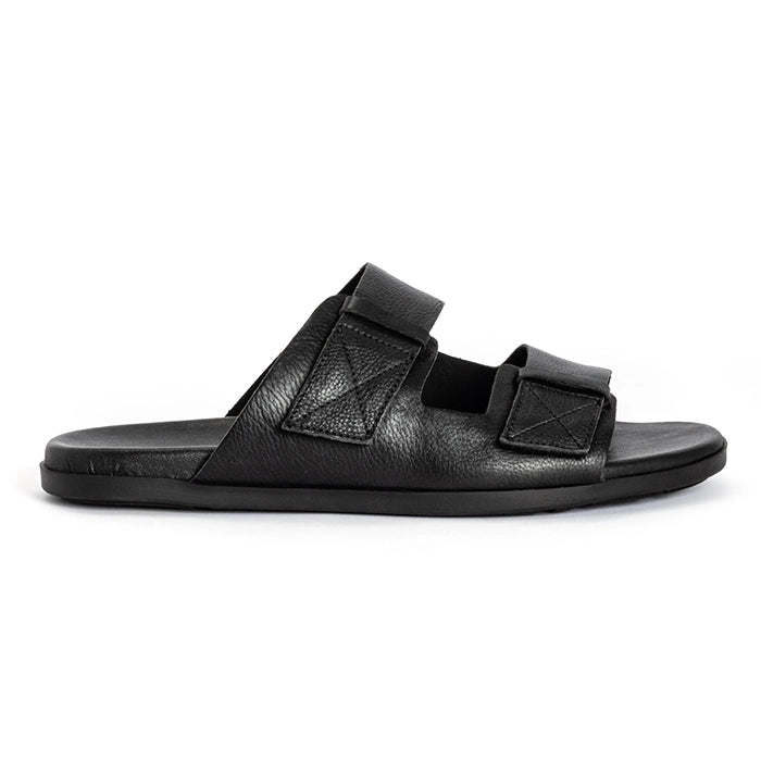 A single black leather slide sandal with two wide adjustable straps, shown in profile against a plain white background.