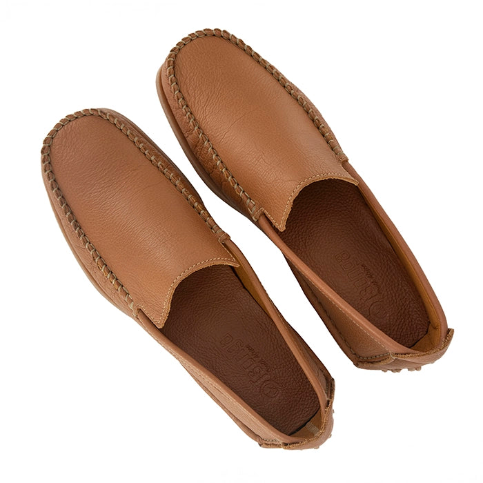 Pair of tan loafers on a white background
