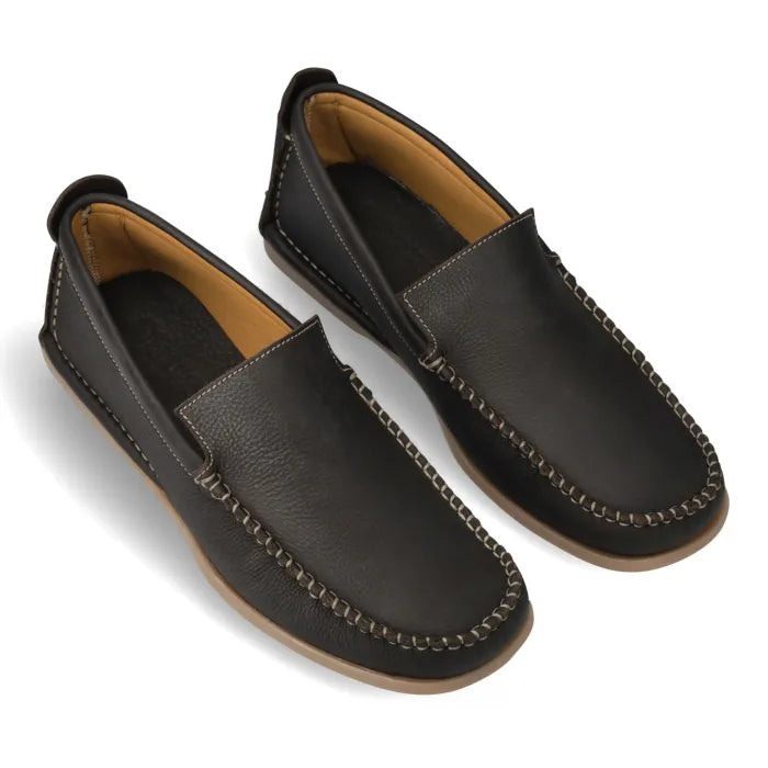 A pair of dark brown leather moccasin-style slip-on shoes with tan lining and a tan outsole, shown on a white background.