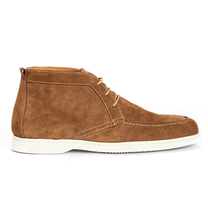 A brown suede chukka boot with beige laces and a thick white sole, shown in a side profile on a white background.