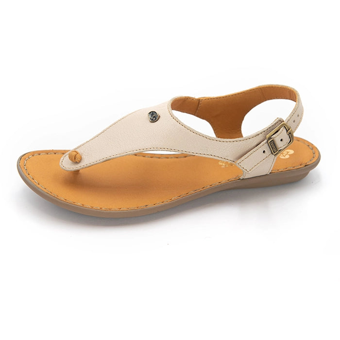A single women's flat thong sandal shown from a side profile on a white background. The upper strap is a light cream/beige leather with a small metal stud, while the footbed and outsole are a warm tan brown.