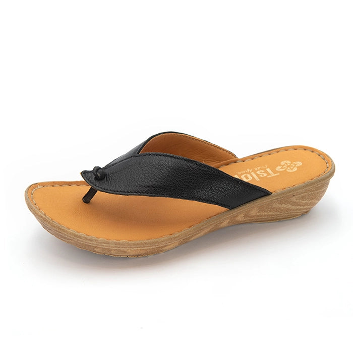 A single women's wedge thong sandal shown from a side profile view on a white background. The sandal features a black leather upper strap with a small decorative knot detail, a tan cushioned footbed, and a cork-textured wedge heel.