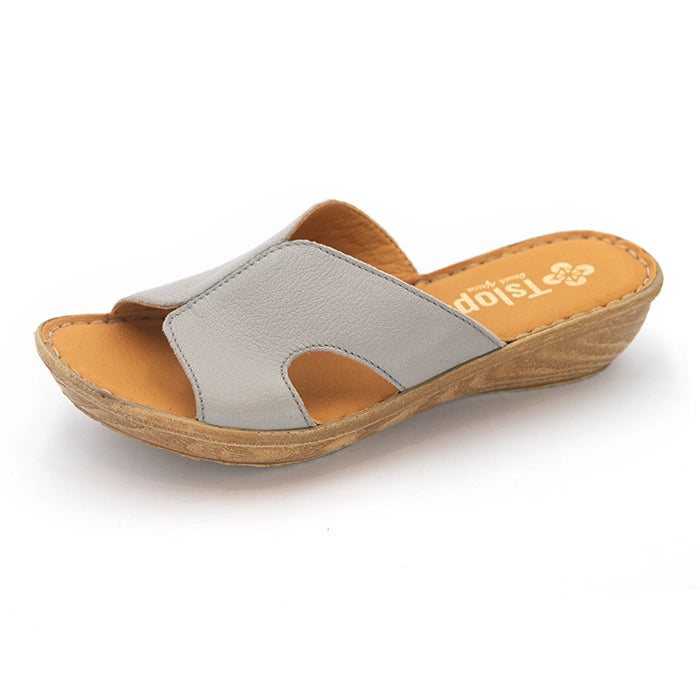 A single women's slide sandal with a light gray textured upper strap, a tan footbed, and a brown wedge sole, shown on a white background.