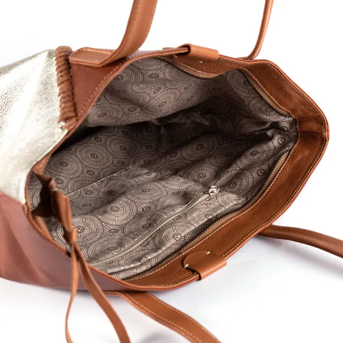 Brown handbag with patterned interior on a white background