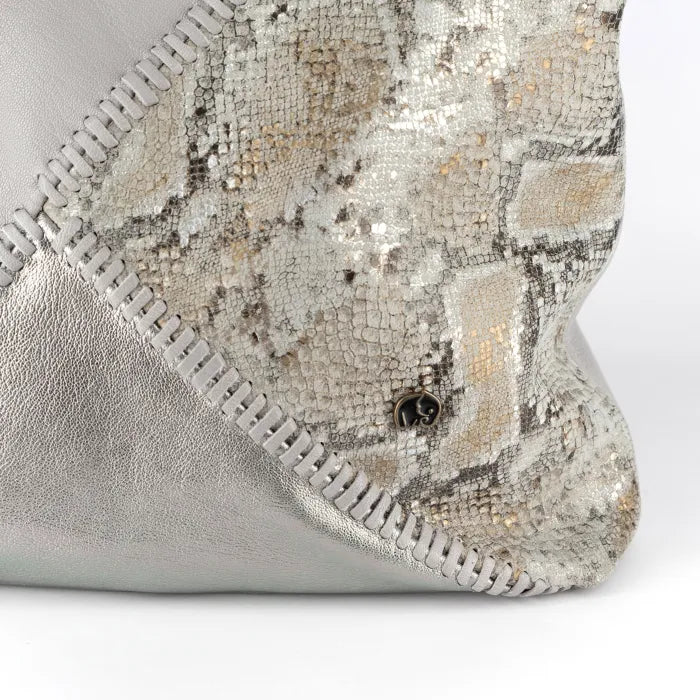 Close-up of a silver tote with print detail on a white background