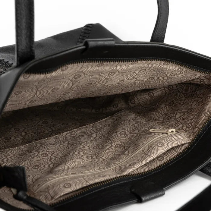 Black leather bag with patterned interior on a white background