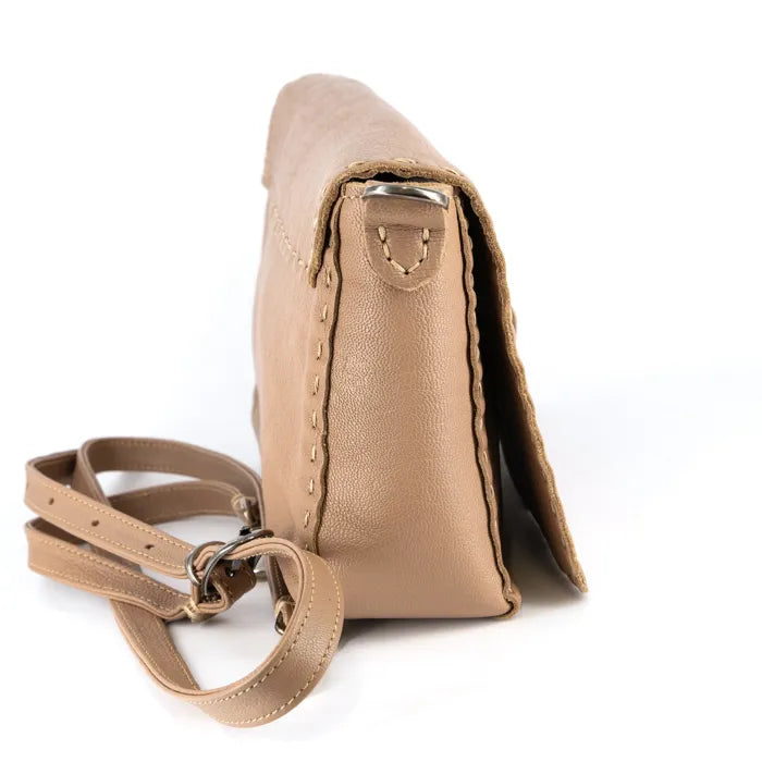 Beige leather handbag with a matching strap on a white background