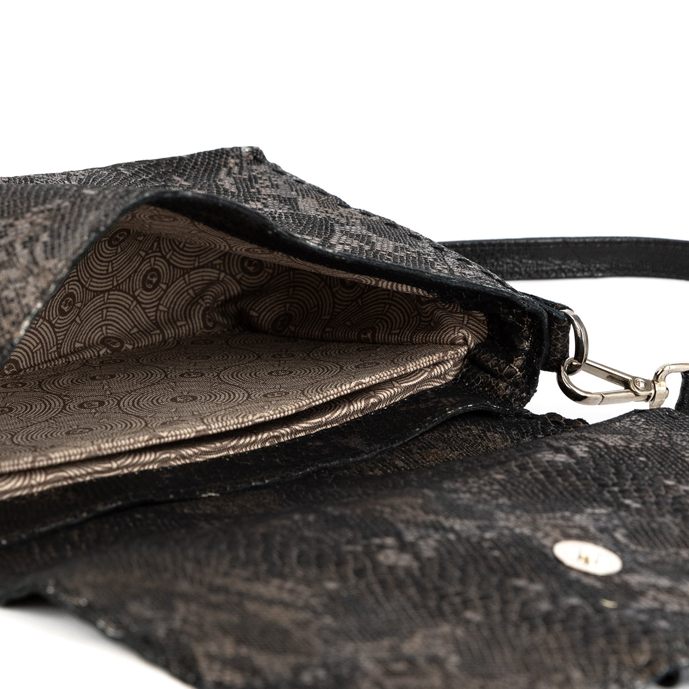 Close-up of a textured black handbag with a visible brand logo.