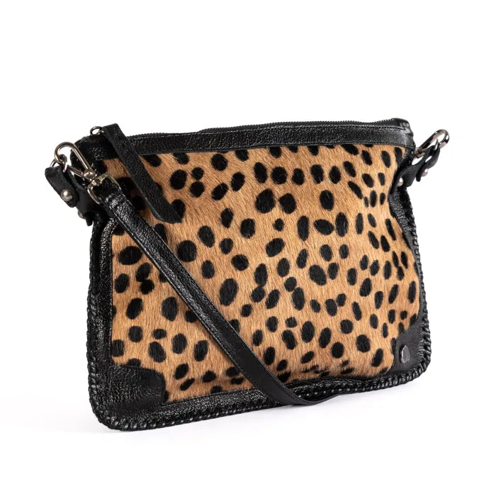 Spotted print handbag with black accents on a white background