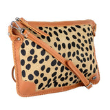 Cheetah print handbag with tan leather strap on a white background