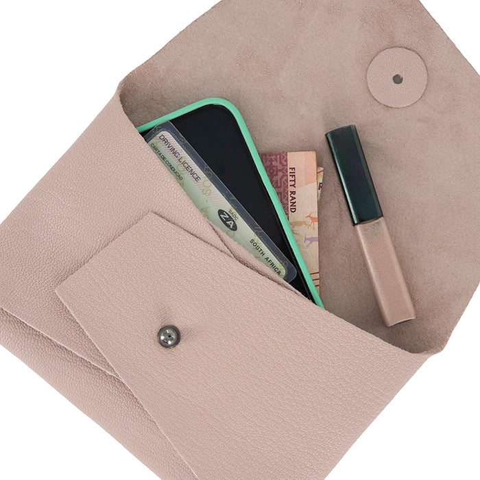 Open pink leather clutch displaying contents including a smartphone, money, ID cards, and lip gloss, with beige suede interior and front pocket.