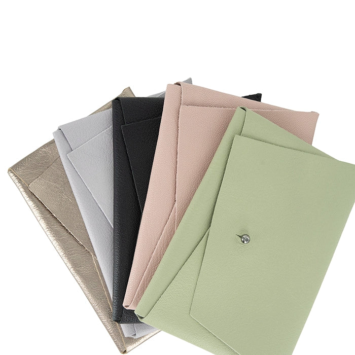 Set of leather purses in various colours on a white background