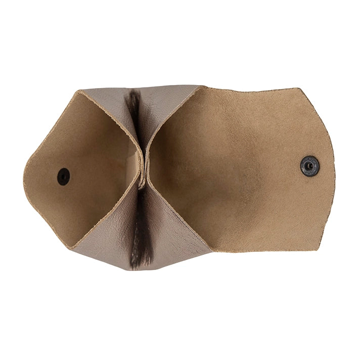 Inside of Metallic leather pouch with black buttons on a white background