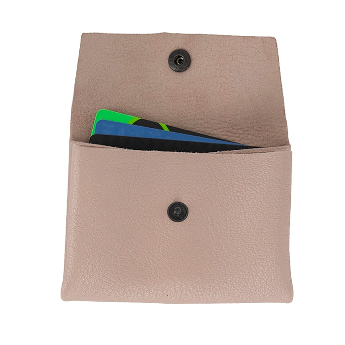 Pink leather cardholder with buttons on a white background