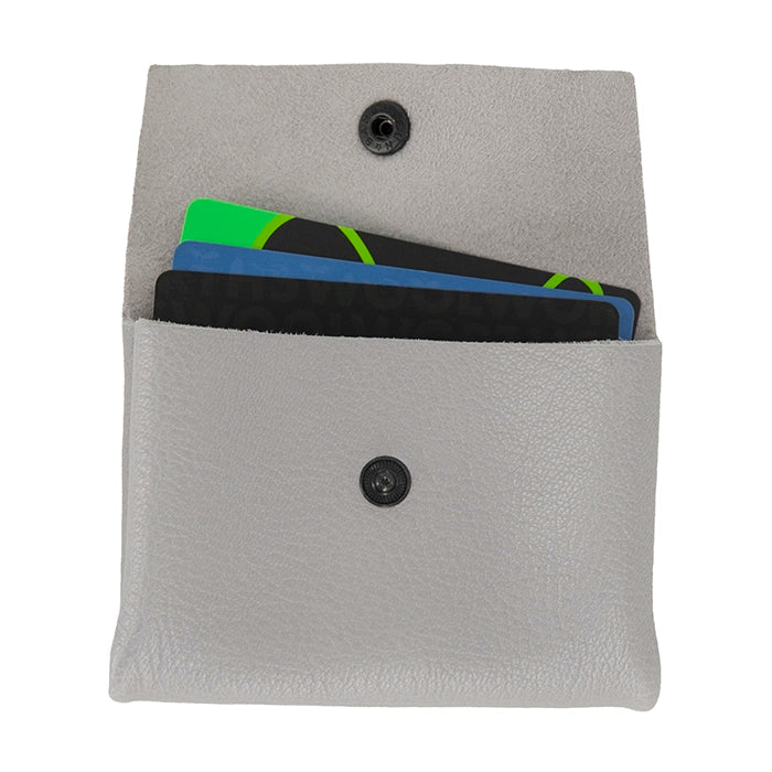 Grey leather pouch with a button closure containing cards on a white background