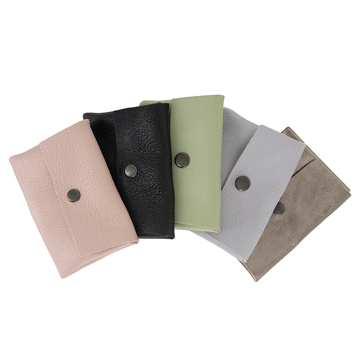 Set of five leather pouches in different colours with button-like fastenings on a white background.