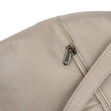 Close-up of a beige leather bag with a zipper