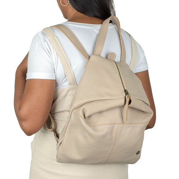Person wearing a beige backpack on a white background