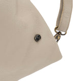 Close-up of a beige handbag with a visible brand logo on a white background
