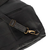 Close-up of a black leather bag with a gold buckle on a white background