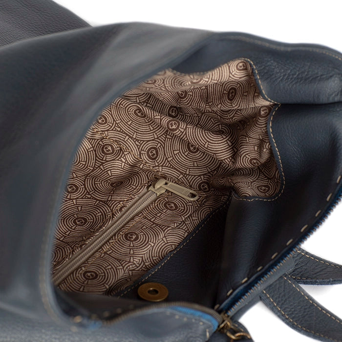 Close-up of a blue leather bag with patterned interior lining.