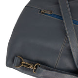 Denim leather bag with gold zipper pull and strap on a white background