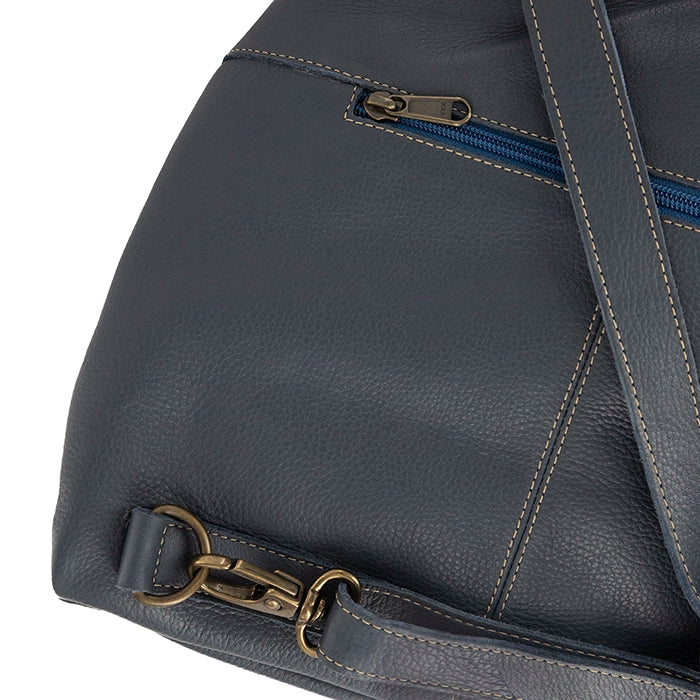 Denim leather bag with gold zipper pull and strap on a white background