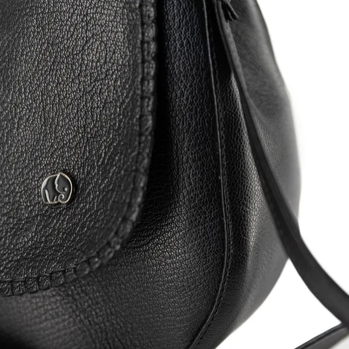 Close-up of a black leather bag with a brand logo on a white background