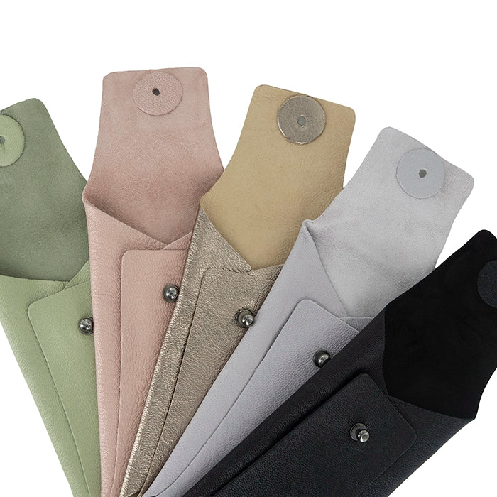 Collection of various colours of sunglass leather pouches, including green, beige, grey, and black.
