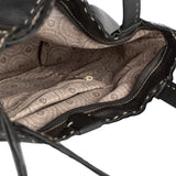 Close-up of a black handbag with patterned interior lining on a white background