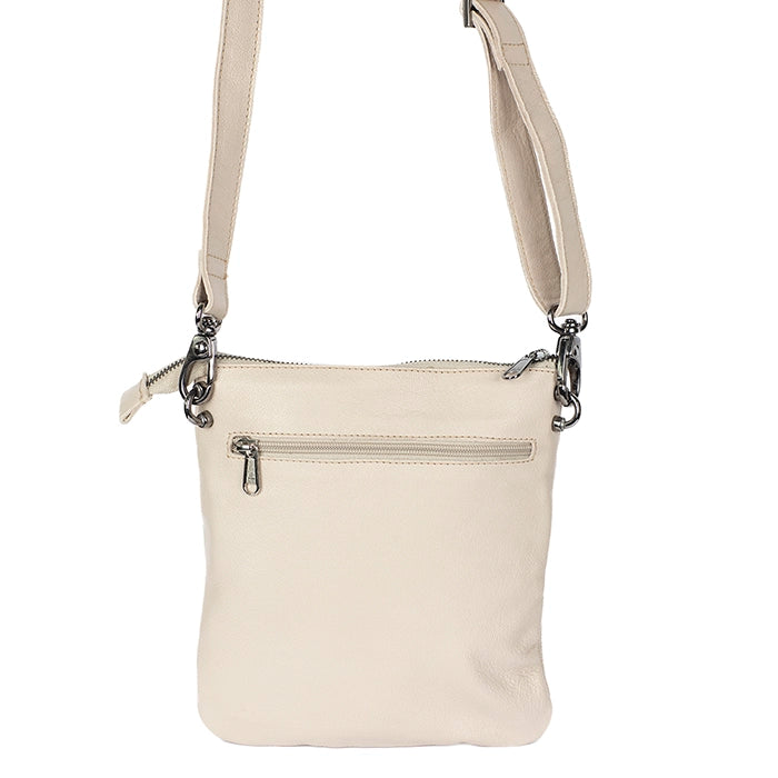 Beige crossbody bag with silver zippers on a white background