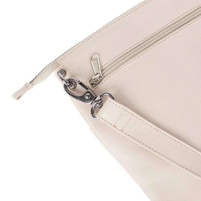 Close-up of a beige handbag with a silver chain strap on a white background