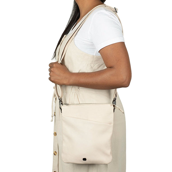Person wearing a beige apron over a white shirt on a white background