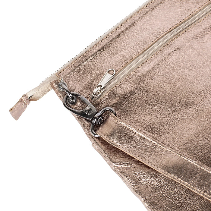Close-up of a gold leather cross body with a zipper on a white background