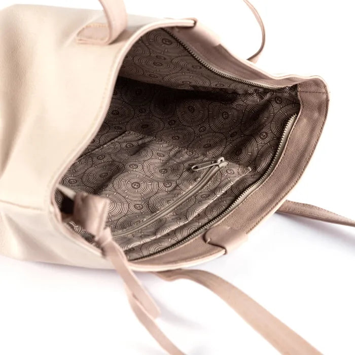 Beige handbag with intricate interior pattern on a white background