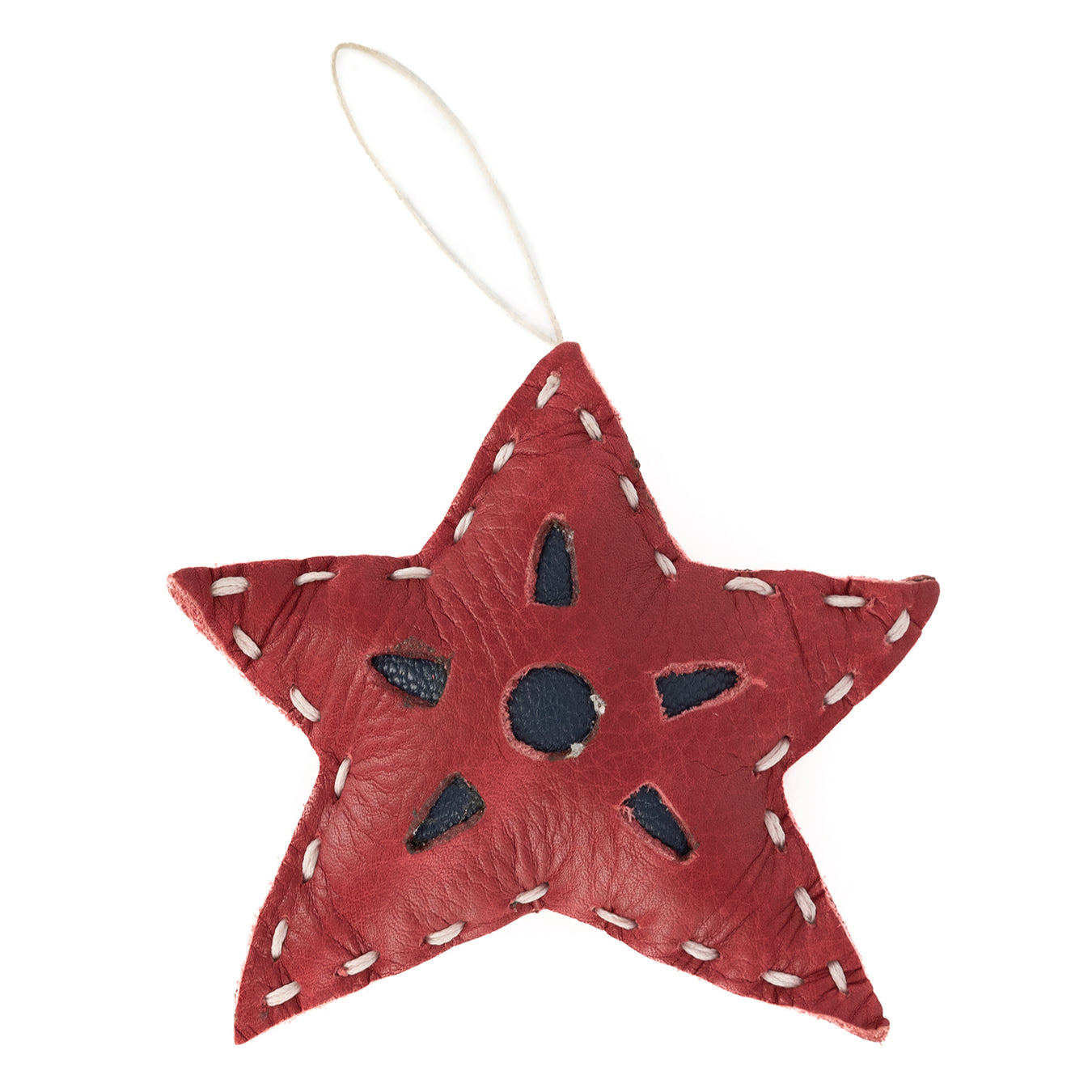A small, red leather Christmas tree accessory shaped like a star with hand lacing detail.