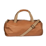 Tan duffel bag with beige handle and strap on a white background