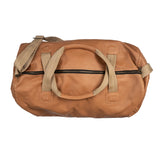 Tan duffel bag with beige straps on a white background
